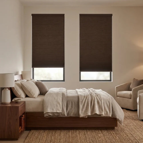 A cozy bedroom featuring Rich Black 1 2 Inch Budget Single Cell Blackout Cordless Shades, ensuring a perfectly dark and restful environment.