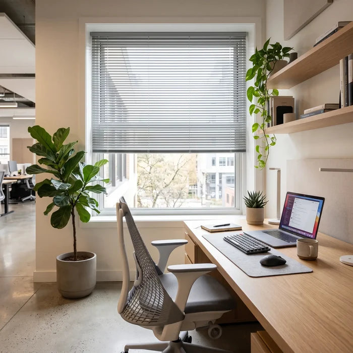 A look at White Classic Cordless 6g Aluminum Mini Blinds inside a cozy workspace, ensuring a clean, cordless aesthetic and enhanced child safety.