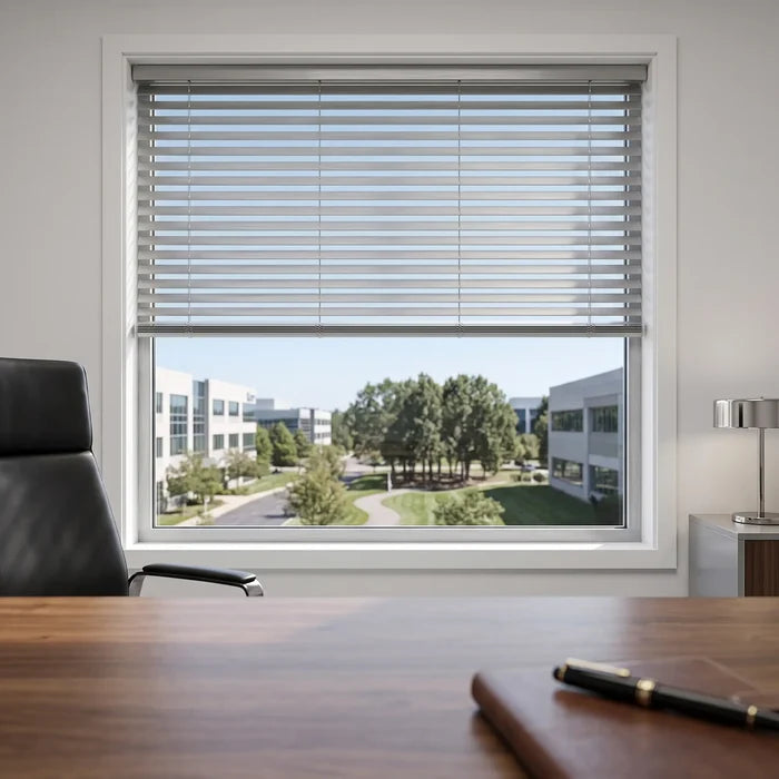 Natural sunlight hits the White Classic Cordless 8g Aluminum Mini Blinds in a cozy workspace, offering lightweight yet sturdy window coverage.