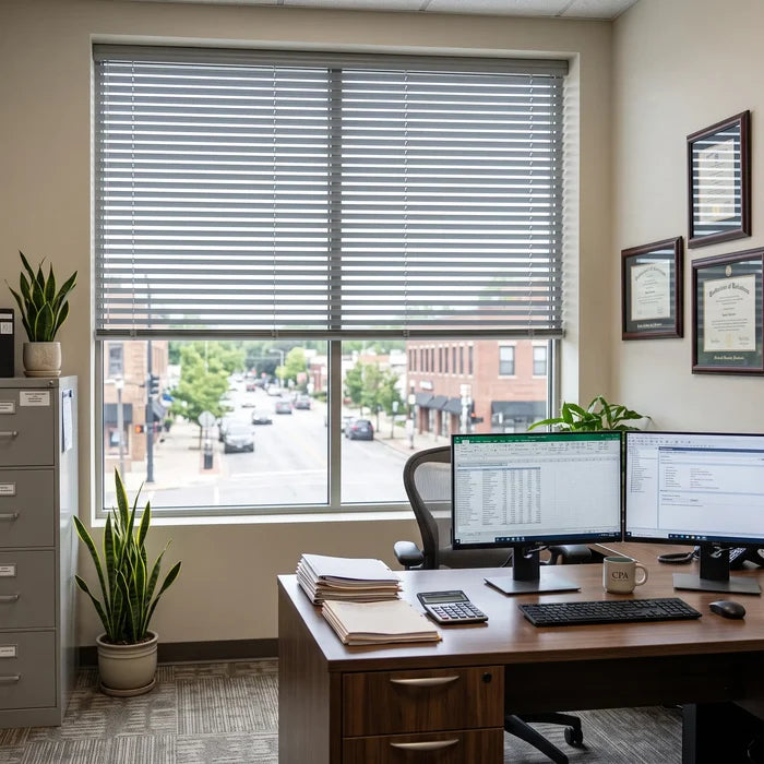 View of a cozy reading with Gray Classic Cordless 8g Aluminum Mini Blinds, creating a streamlined look with its cordless lift mechanism.