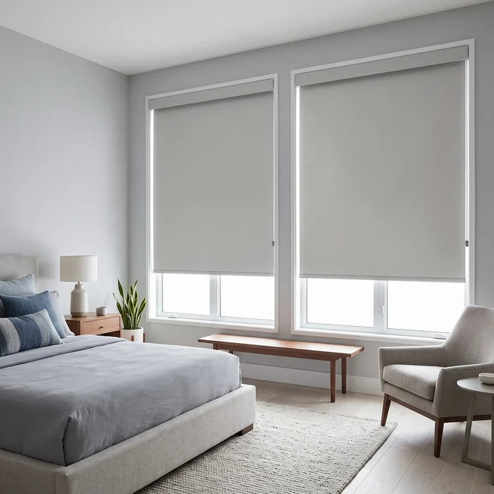 Gray Classic Blackout Vinyl Roller Shades on twin bedroom windows in a cool neutral palette