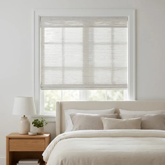 Cordless Woven Wood Shades beautifully filter natural light into this inviting bedroom, where a beige bedframe and creamy pillows create a peaceful retreat
