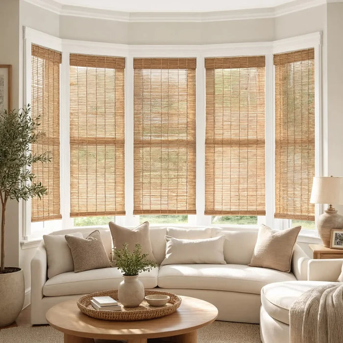 Transform your living space with Cordless Woven Wood Shades, perfectly complementing brown bamboo accents and white walls for a harmonious atmosphere.