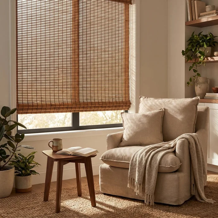 Cordless Woven Wood Shades effortlessly filter natural light, complementing the serene atmosphere in this peaceful study space with a chair and tasteful decor.