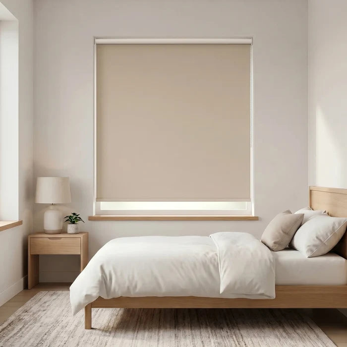Economy Basic Vinyl Blackout Roller Shades in a cozy bedroom setting, providing a neutral cream beige backdrop and blocking out light for a peaceful atmosphere.