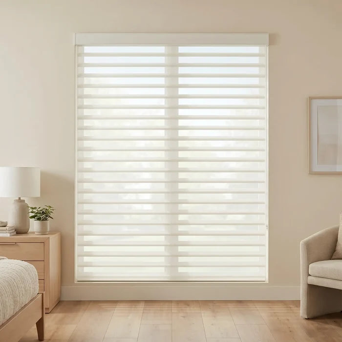 Window with white light dimming sheer shades blinds in a room with a bed, nightstand, and chair.