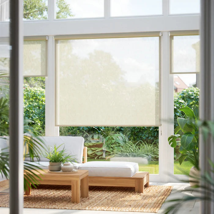 Gold-toned Champagne Luxe Decorative Solar Shades with 4 percent openness, installed in a bright sunroom to reduce glare while maintaining a view.