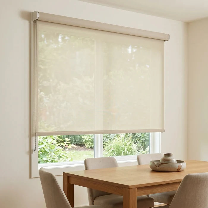 Premier 1% Solar Screen Roller Shade filters natural light while maintaining views, blocking 99% of UV rays and heat in this modern dining area with creamy white accents.
