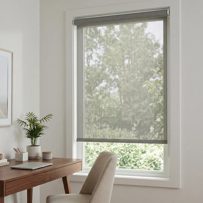 Premier 14% Solar Screen Roller Shade in a sun-drenched living room with minimalist decor, offering elegant UV protection and subtle warmth.