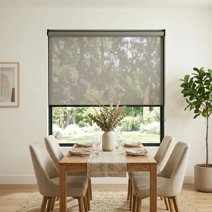 Enhance your dining area with Premier 5% Solar Screen Roller Shade, providing a calming atmosphere and UV protection while filtering in soft gray sunlight.