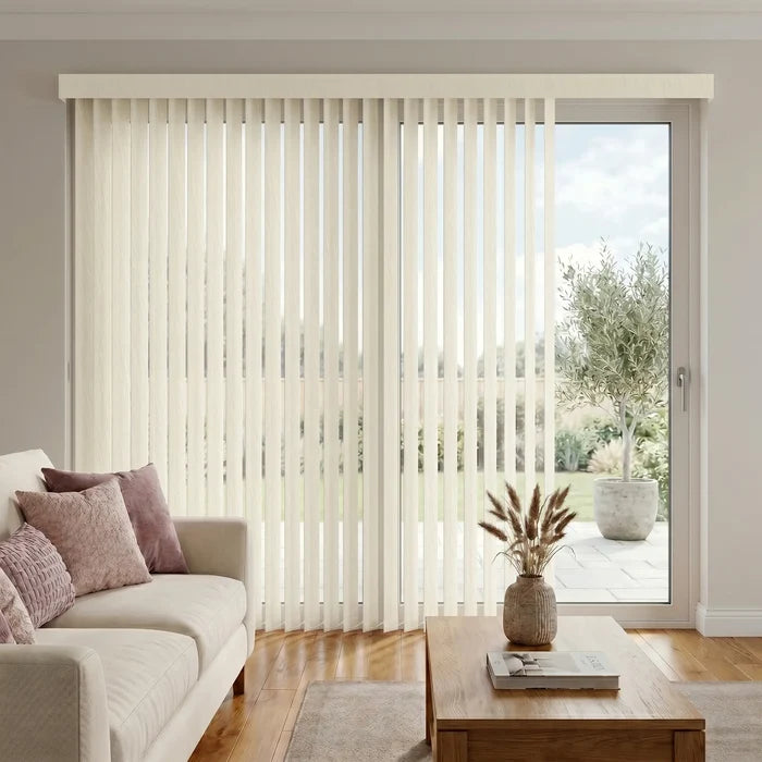 View of a serene living space with Soft White (Costa Rica Seashell) Premier Pvc Vertical Blinds, delivering sleek functionality and room-darkening capabilities.