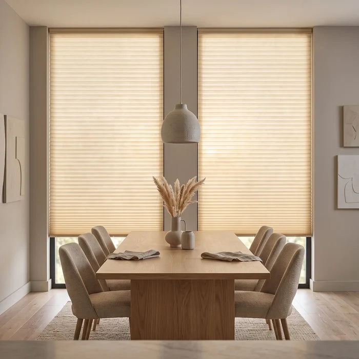 Simplistic Cordless Pleated Shades in Cream effortlessly filter natural light, complementing beige curtains and modern minimalism in this serene dining room.
