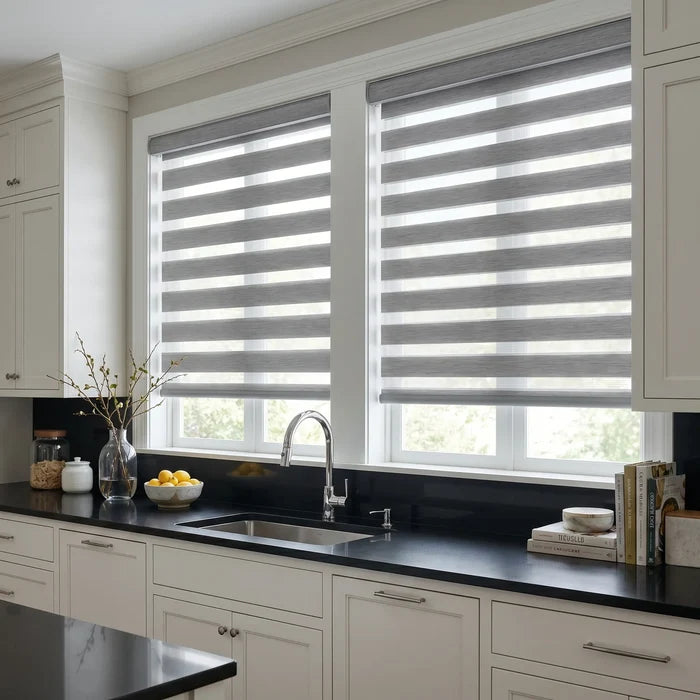 Zebra Room Darkening Roller Shades provide soft gray filtering in modern kitchens, while blocking light and maintaining elegant style with these window treatments.