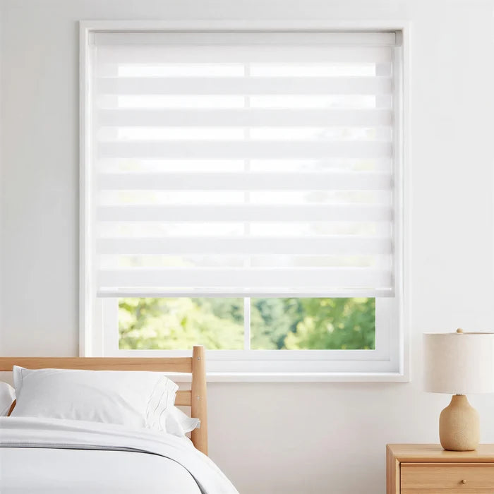 Modern bedroom serenity with Zebra Solar Roller Shades offering UV protection and effortless natural light control.